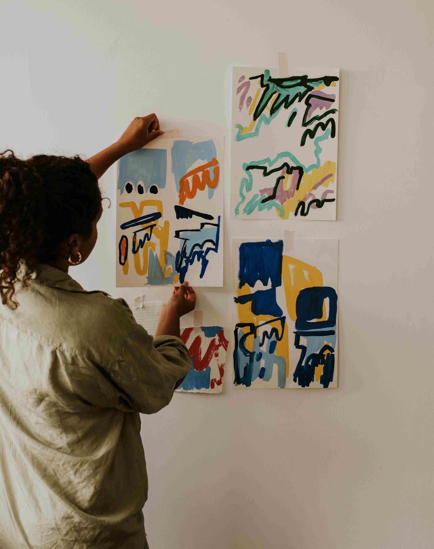 woman-hanging-art-on-wall-in-home-studio-2026-03-05-11-56-50-utc_11zon