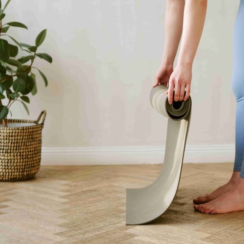 adult-rolling-up-a-yoga-mat-at-home-2026-03-05-11-40-37-utc_11zon